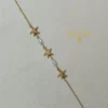 PULSERA DE ACERO DORADO CON ESTRELLAS DE MAR Y PERLAS