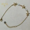 PULSERA DE ACERO DORADO CON ESTRELLAS DE MAR Y PERLAS