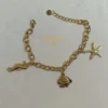 PULSERA ERYNA CHARMS MARINOS ACERO DORADO