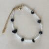 Pulsera ERYNA con imitación de ágata negra y cristales blancos sobre fondo claro