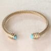 Pulsera rígida dorada ERYNA con piedra turquesa