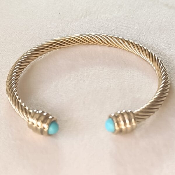 Pulsera rígida dorada ERYNA con piedra turquesa