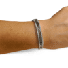 PULSERA ERYNA RÍGIDA DE ACERO INOXIDABLE CON CADENA Y CIRCONITAS 1 Pulsera ERYNA rígida de acero inoxidable con cadena y circonitas en la muñeca