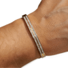 PULSERA RÍGIDA ERYNA DORADA CON DOBLE FILA DE CIRCONITAS 1 Pulsera ERYNA rígida dorada de acero inoxidable con circonitas en la muñeca