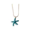 Colgante estrella de mar esmaltada turquesa con lunares blancos y cadena dorada fina